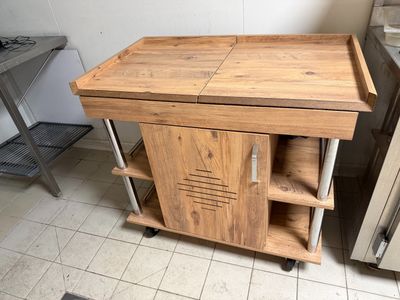 a small wooden table with a shelf on top of it