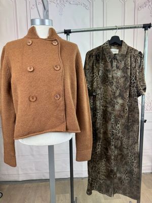 two coats on display on a stand in a room