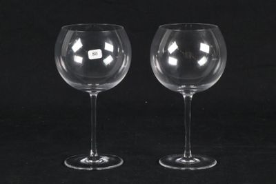 pair of clear wine glasses on a black background