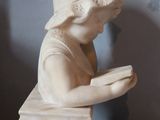 a statue of a woman that is sitting on a table