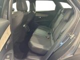 the back seats of a car with the door open and the driver ' s seat down