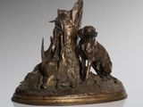 an image of a bronze statue of a woman and two dogs