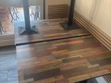 a wooden bench and a table in the corner of a room