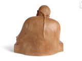 sculpture of a woman sitting on a bench with her back to the camera