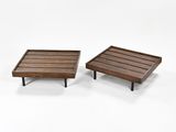 two wooden trays with metal legs on a white surface