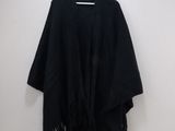 the black shawl is hanging on a hanger on the wall