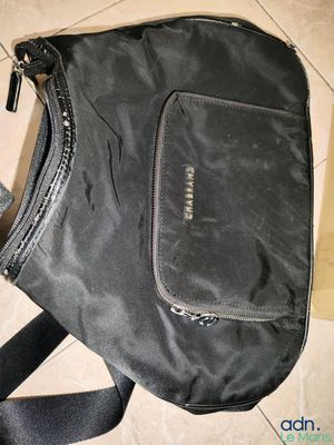 a black bag with a zipper on it sitting on the floor