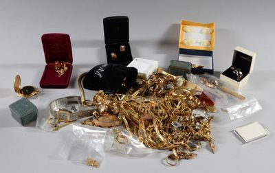a pile of gold and other jewelry on a table