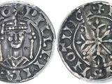 a close up of two silver coins on a white surface