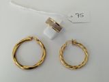 two pairs of gold hoop earrings and a ring