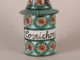 a ceramic jar with a lid that says cornichurine on it