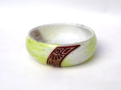 un bol blanc orné d'un motif rouge
