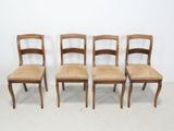 four wooden chairs with cane back and cane seat cushions