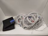 a pile of wires and a laptop on a white table