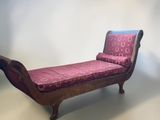 a wooden bench with a pink cover on it