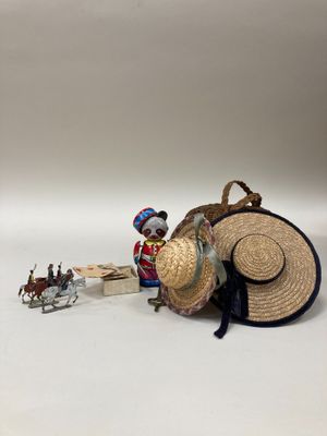 a small figurine of a man with a straw hat and a sleigh