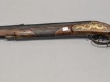 a rifle that is on display on the wall