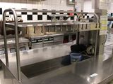 stainless steel counter tops in a commercial kitchen with a checkered wall