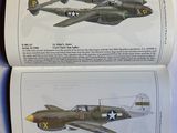an open book with a picture of a fighter plane and a picture of a fighter plane