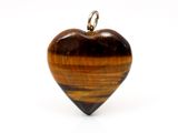 tiger ' s eye heart pendant on a chain on a white background