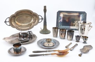 a silver plate and silverware on a white table
