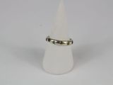 sterling silver ring with peridot stones on a white cone