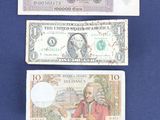 three different types of paper money are displayed on a blue surface