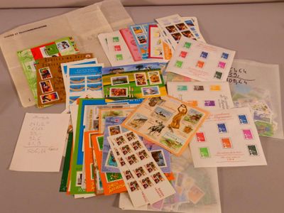 a pile of stamps and envelopes sitting on a table