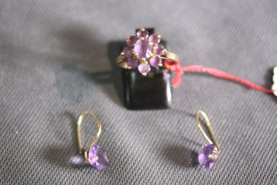 a pair of earrings and a ring sitting on a table