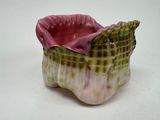 a pink and green vase with a green and white design on it
