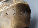 a close up of a wooden shoe on a table
