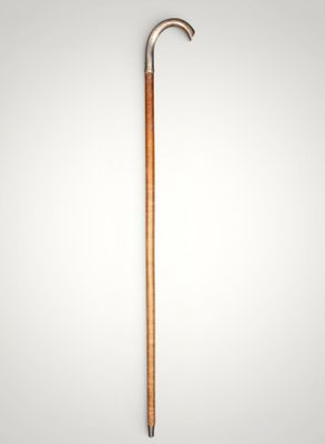 an old cane with a wooden handle on a white background