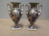 two vases that are sitting on a table