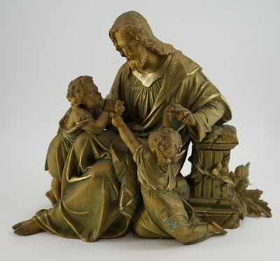 statue en bronze représentant un homme et deux enfants assis par terre