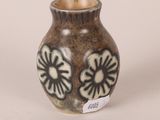 a brown vase with black and white designs on it