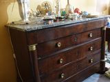 a dresser with a lamp on top of it in a room