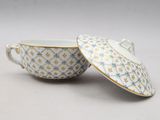 a close up of a cup and saucer on a white surface