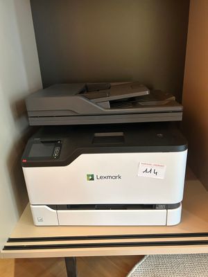 a printer sitting on top of a shelf in a room