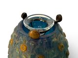 a blue vase with a ring on top of it