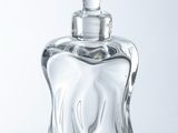 a glass bottle with a flower on top of it
