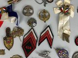 a lot of badges and pins on a white surface