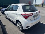a white toyota yaris parked in a parking lot