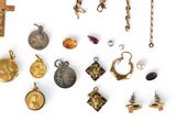 a lot of different types of jewelry on a white surface