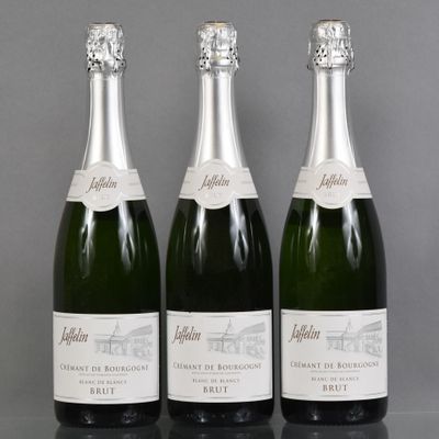 three bottles of champagne sitting on top of a table next to each other