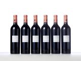 six bottles of red wine lined up in a row on a table
