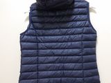 a close up of a blue vest hanging on a wall