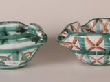 two small bowls sitting next to each other on a table