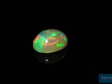 a black oplite with green and red lights in the dark