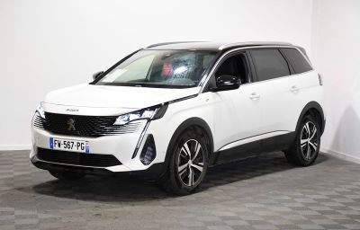 le SUV blanc est garé dans une pièce au sol en damier