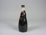 a black bottle with a white cap and orange ribbon on it